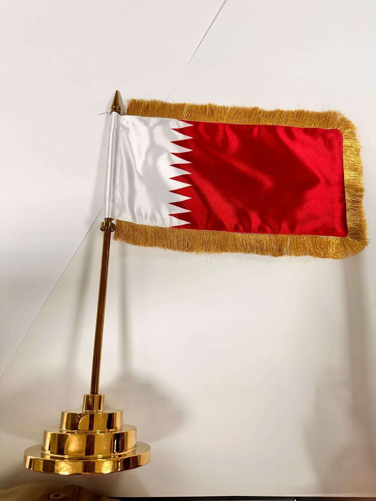 Satin table flag with gold fringe finish on a gold plated desktop flagpole