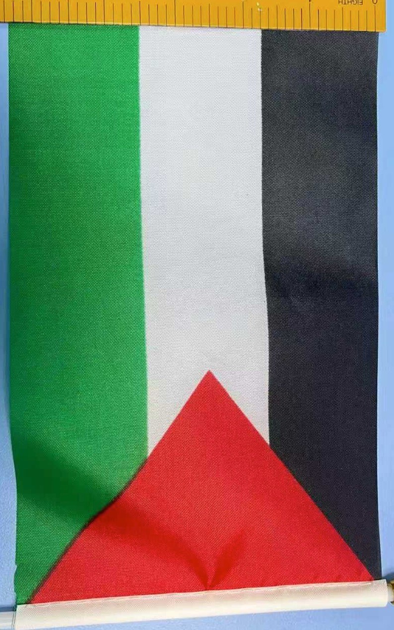 Close-up of a polyester table flag showing the single-sided print and the mirrored reverse showing through the fabric