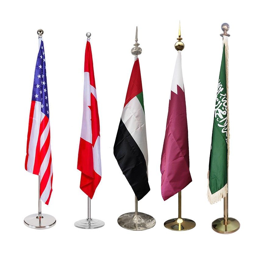 Indoor flagpoles with national flags on a polished base